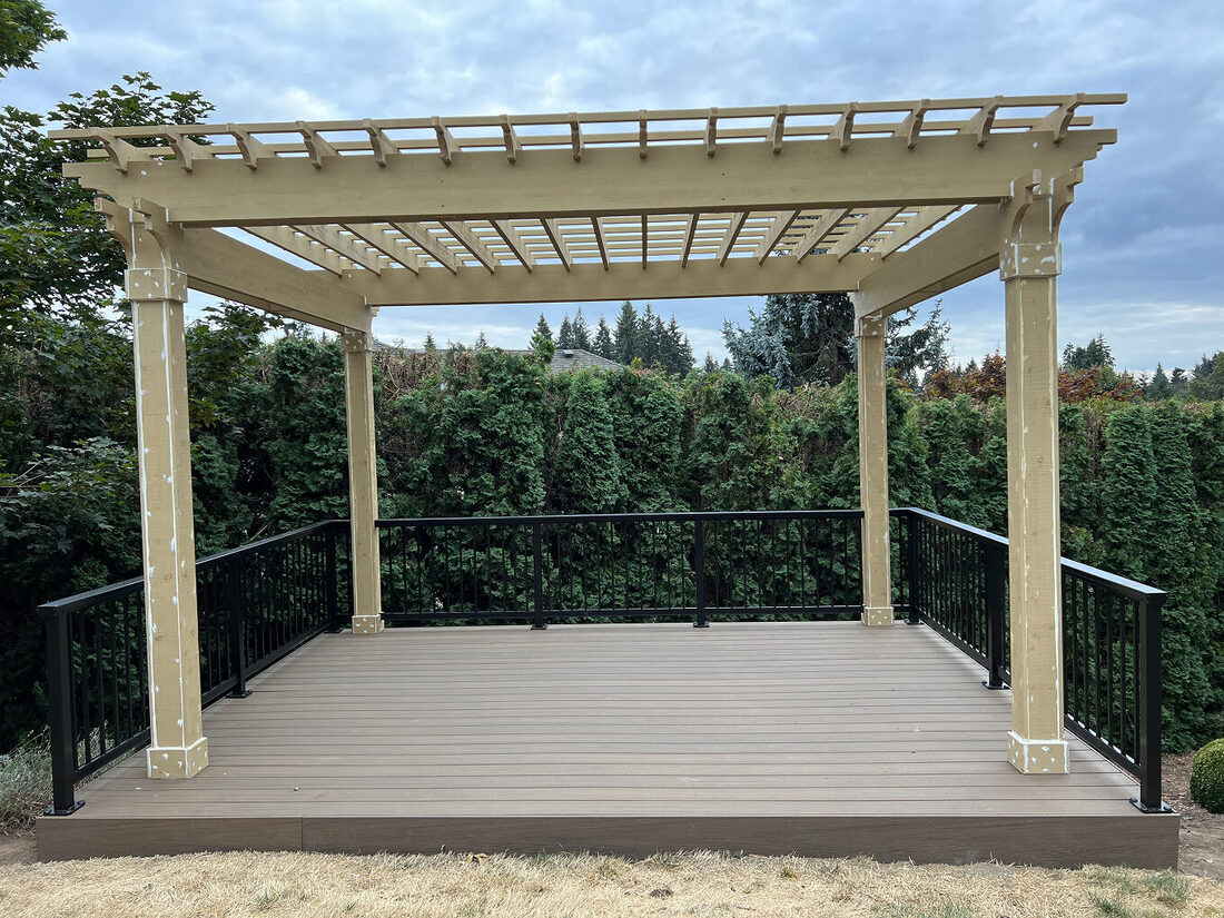 Custom cedar pergola built over a composite deck with railings