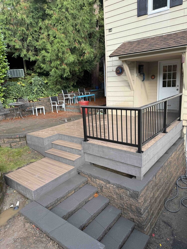 Composite front porch with aluminum railing and concrete stairs
