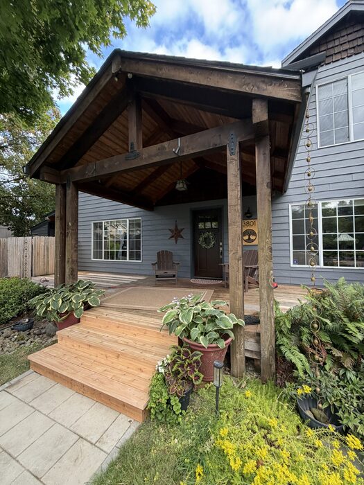 Custom front entry porch with timber posts and wood decking