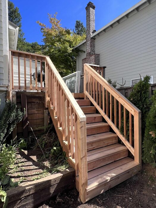 Wood deck stairs with cedar railings
