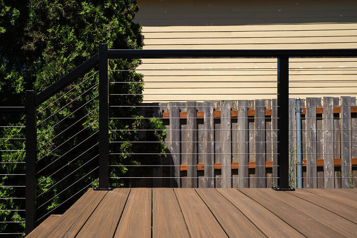 Black aluminum cable railing on a composite deck