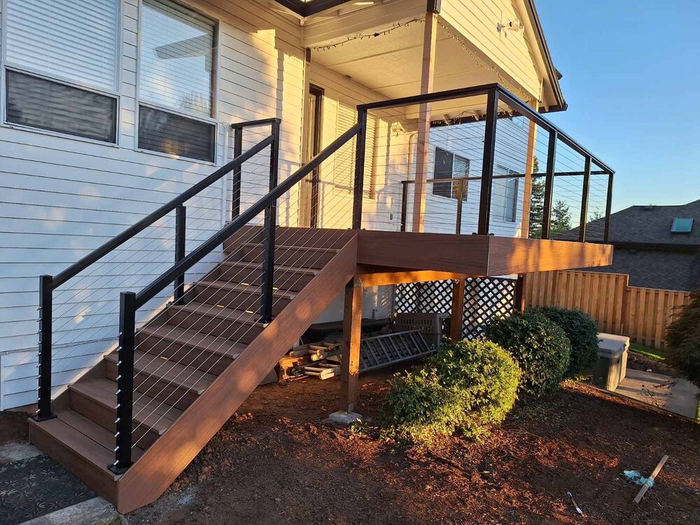 Elevated composite deck with cable railing and custom staircase