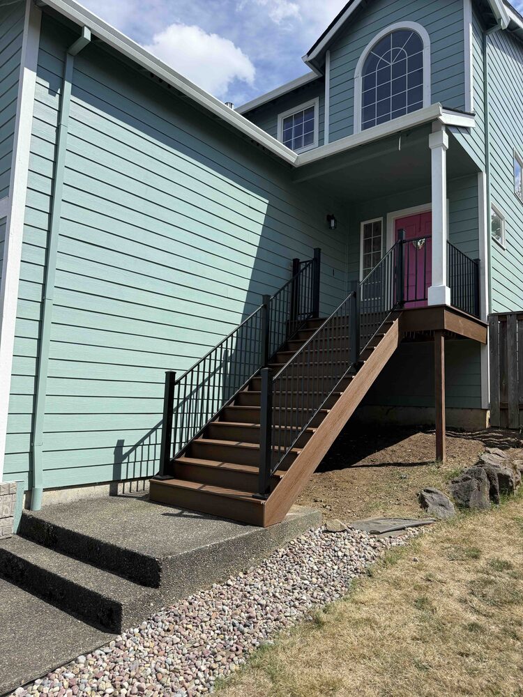 Custom front entry stairs with black railing