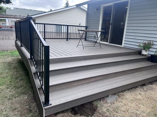 Composite deck stairs with black aluminum railing