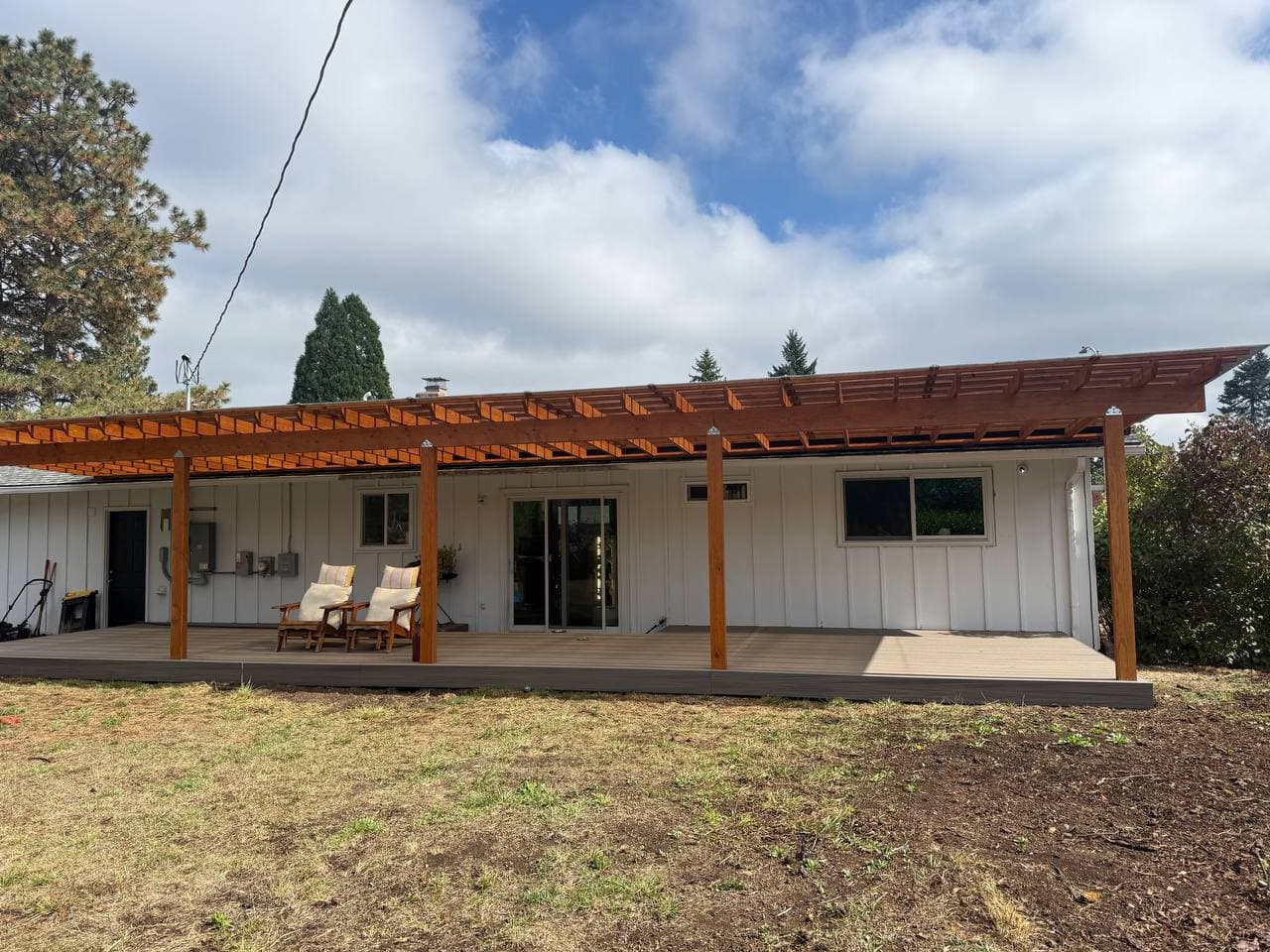 Long backyard deck with pergola cover