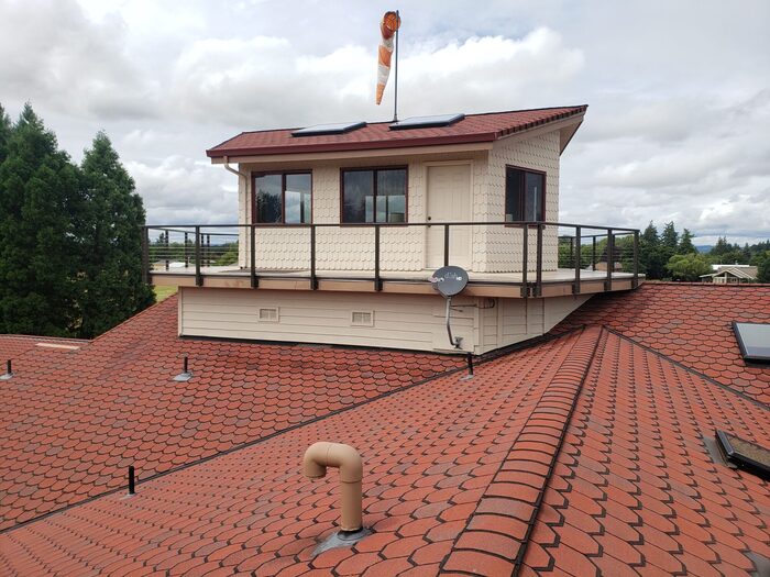 Elevated deck installed over living space with a waterproof deck system