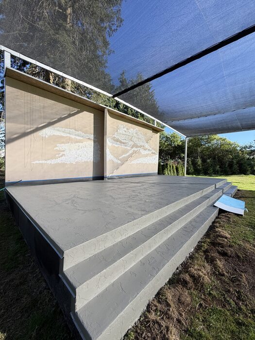 Textured waterproof deck coating on elevated outdoor stairs and deck